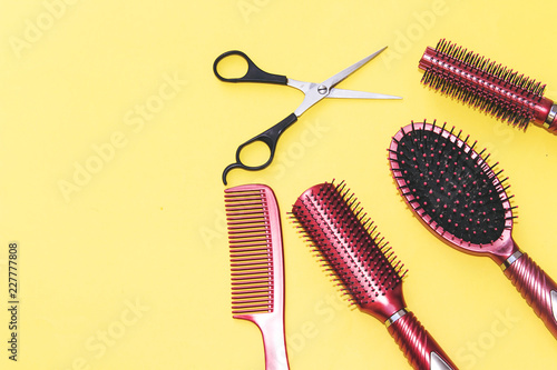 Professional hairdressing tools isolated on yellow background with copy space