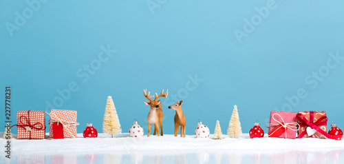 Christmas holiday theme with reindeer and Christmas trees