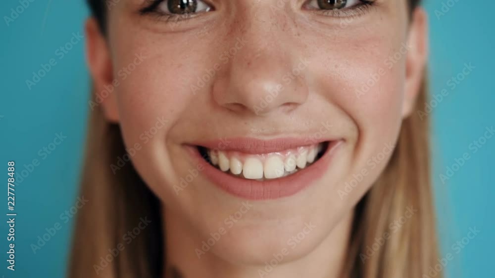 Close up of a teen cute girl face. Portrait shot. Close-up face of a beautiful blonde with dark eyes and beautiful smiling Close up of a teen cute girl face. Portrait shot. Close-up face of a beautiful blonde with dark eyes and beautiful smiling