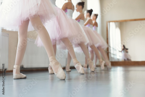 Obraz na plátně Group of young girls dancing ballet in studio