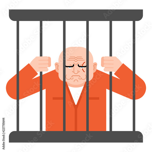 Prisoner in jail. convict holds on to bars.