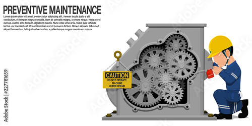 An industrial worker is lubricating the machine