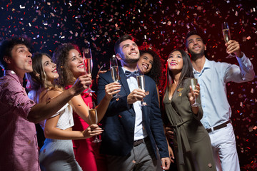Happy diverse friends celebrating New Year together