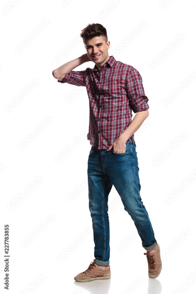 relaxed casual man holding neck walks to side and smiles relaxed casual man holding neck walks to side and smiles