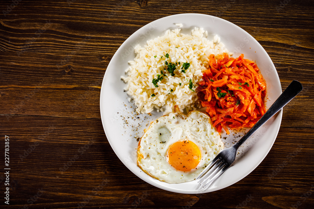 Fried egg with rice and vegetables Fried egg with rice and vegetables
