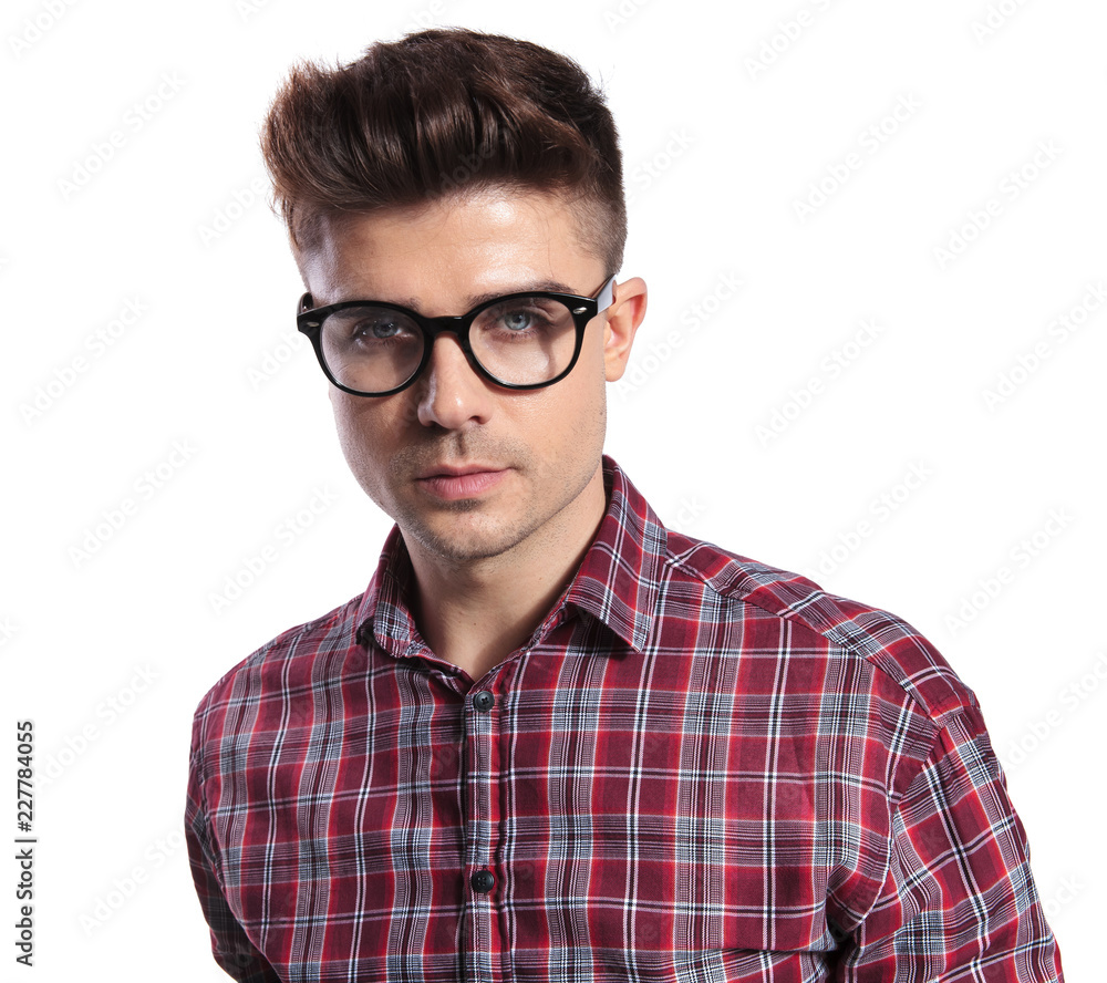 portrait of geek wearing glasses and shirt with red plaids