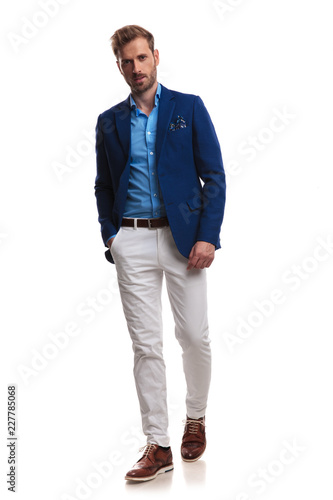 stylish  man walking with coat open and hand in pocket