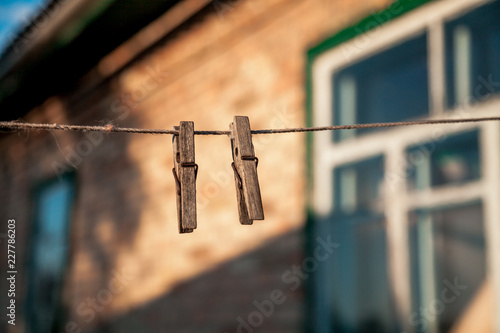 Wooden clothespins hanging on rope