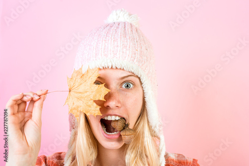 Happy young woman are preparing for autumn sunny day. Sweet young woman wearing in autumn clothes on autumn rain day. Beautiful girl with background board for Copyspace.
