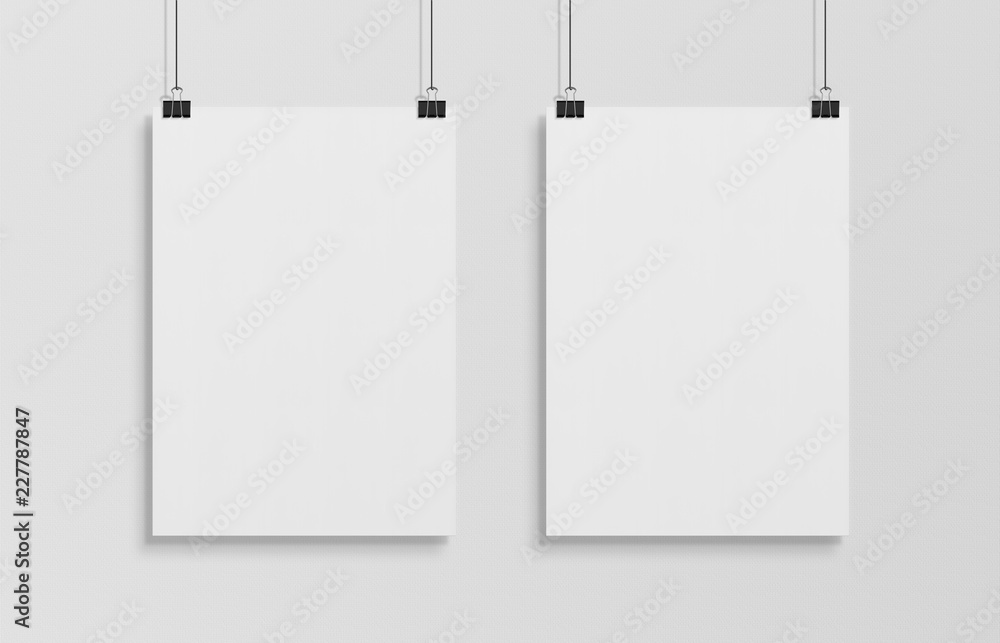 Two blank white poster hanging up with clips mockup Two blank white poster hanging up with clips mockup