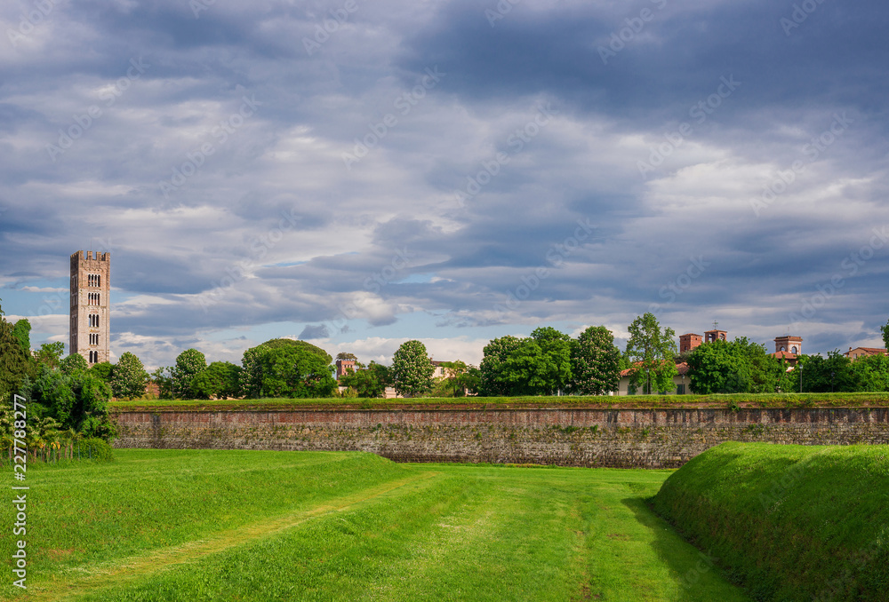 Panoramic view of Lucca historic center skyline with medieval towers seen from ancient walls public park