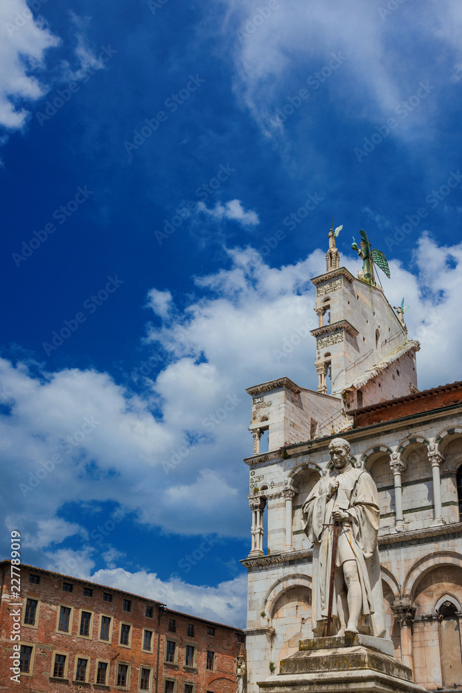St Michael in Foro Square ancient monuments in Lucca medieval  historic center, with clouds above