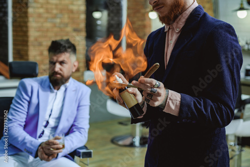 Shaving man and razor man. Barber shaving a bearded man in a barber shop. Barber shop tools on old wooden background with copy space. Barber shop. Portrait of stylish man beard. photo