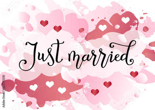 Modern handwritten calligraphy of Just married in black on pink watercolor background decorated with white and pink hearts for decoration, postcard, poster, wedding, scrapbooking, album, banner