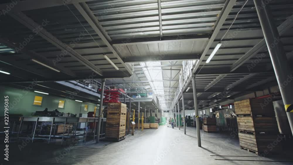 Walking through a factory warehouse with crates and pallets for storage of supplies. Walking through a factory warehouse with crates and pallets for storage of supplies.