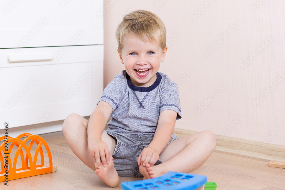 The little toddler boy using imagination to assemble toy train to cultivate ideas, close up on hands The little toddler boy using imagination to assemble toy train to cultivate ideas, close up on hands