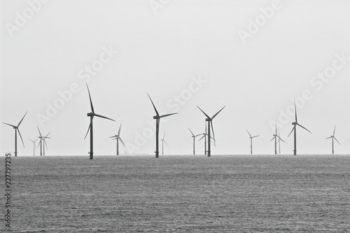 An image of a North Sea wind farm as seen from the balcony of a cruise ship on a very grey day.