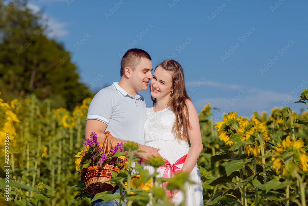 couple in love husband and wife walking in sunflower field outdoors