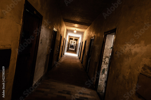 An old corridor of a creepy prison abandoned a long time ago. photo