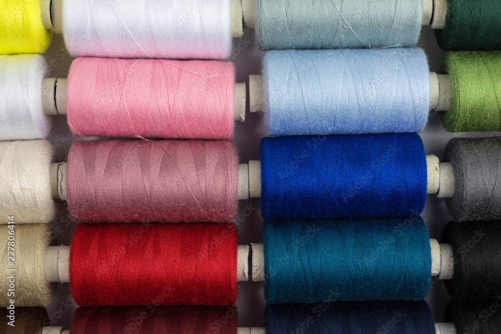 spools of sewing thread in various colors spools of sewing thread in various colors
