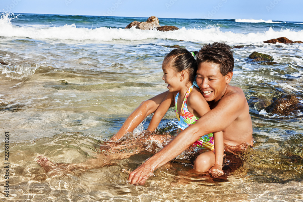 father and daughter at the beach playing father and daughter at the beach playing