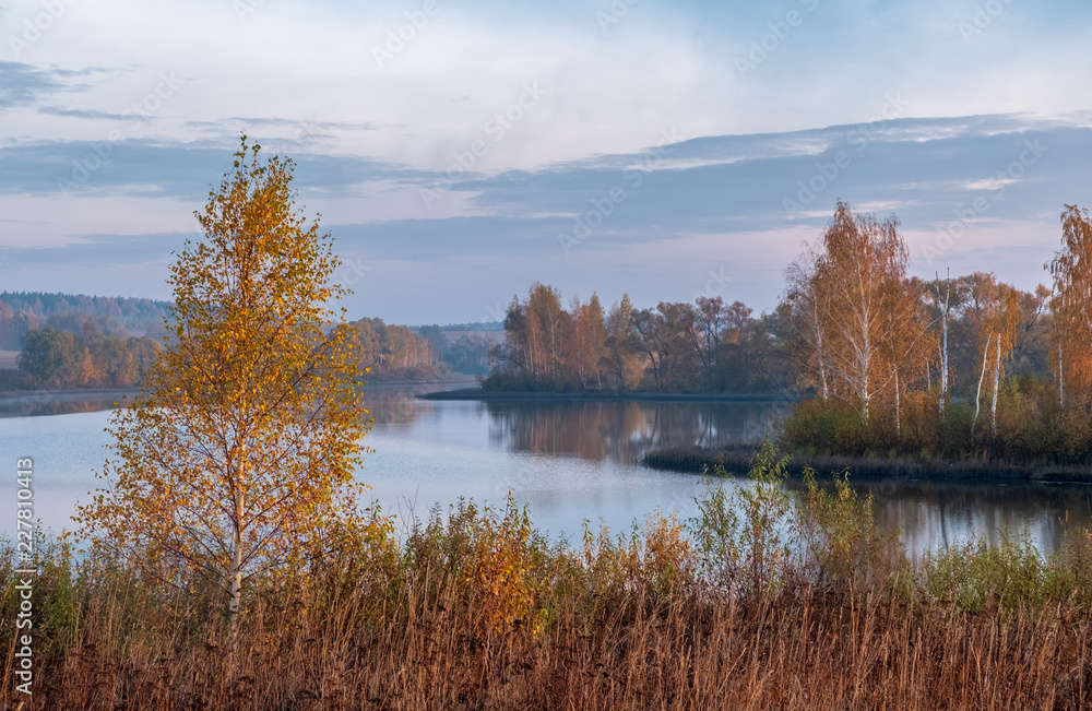 beautiful autumn landscape with a view of the lake at dawn