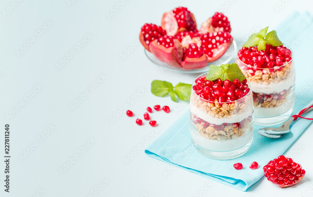Pomegranate parfait - sweet organic layered dessert with granola flakes, yogurt and ripe fruit seeds. Pomegranate parfait - sweet organic layered dessert with granola flakes, yogurt and ripe fruit seeds.