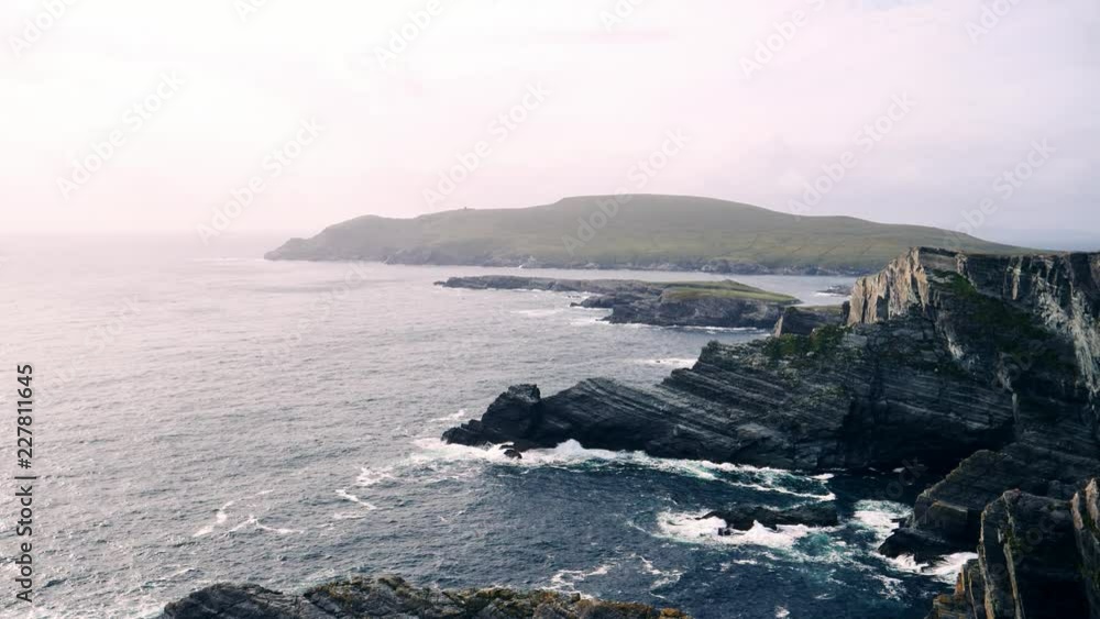 Cliffs and waves at the Irish coast on a foggy day Cliffs and waves at the Irish coast on a foggy day