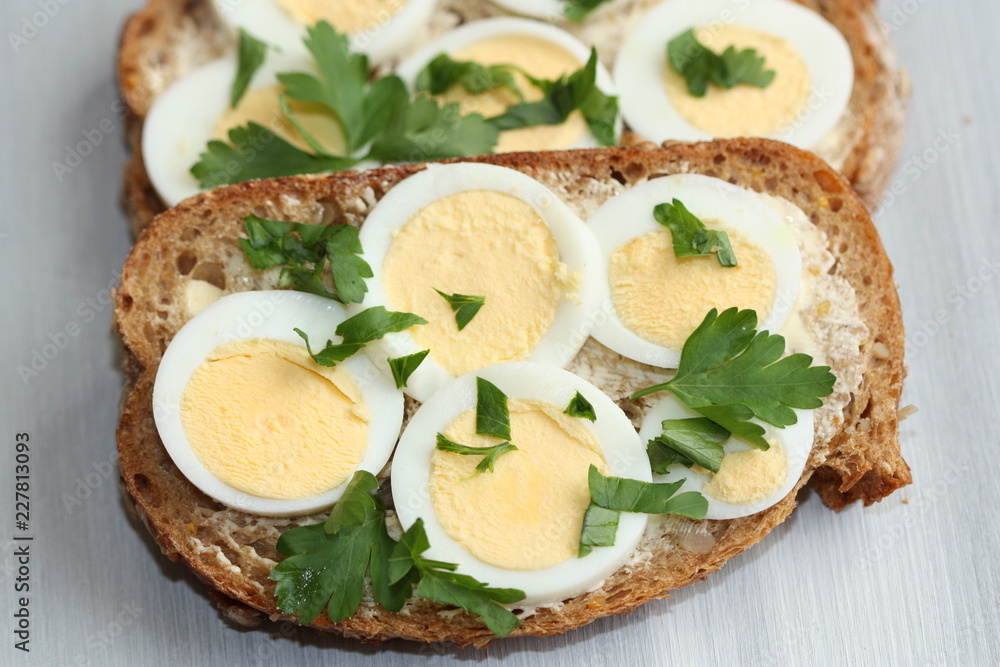Sandwich with boiled egg and parsley.