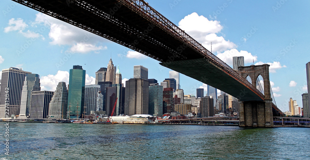 New York, USA - August 5, 2014: New York city Lower Manhattan skyline and Brooklyn bridge viewed from a boat
