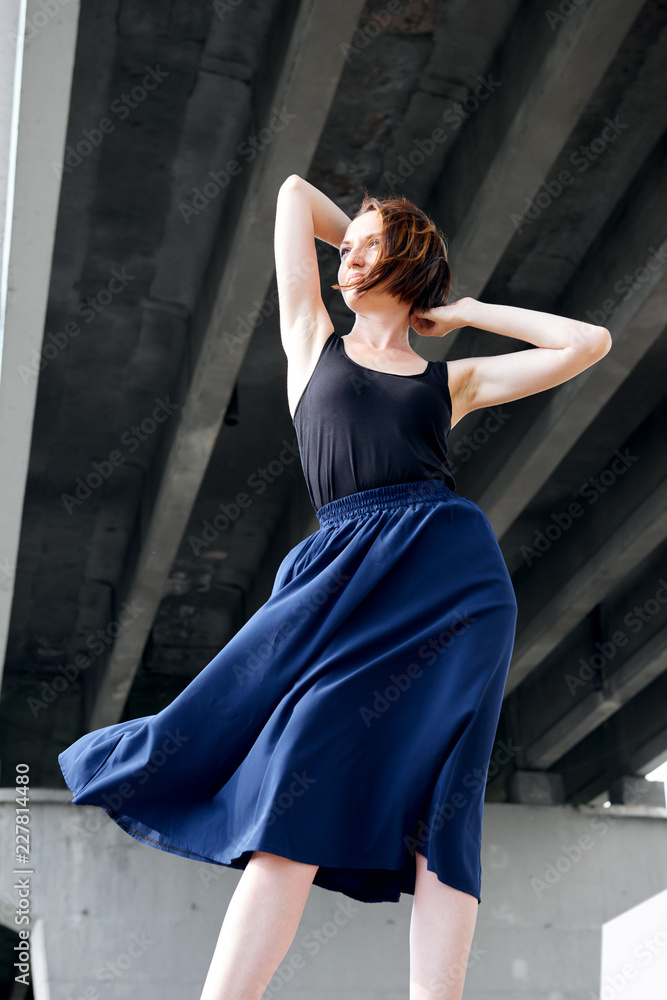 young girl posing under the bridge, dressed in black, modern architecture young girl posing under the bridge, dressed in black, modern architecture