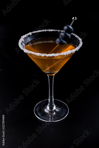 orange cocktail with salt and blueberry brochette