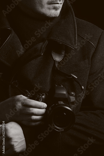 Brutal male photographer with a camera in his hands