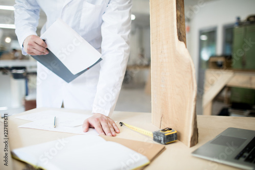 Contemporary engineer studying new material for cabinetmaking and its description