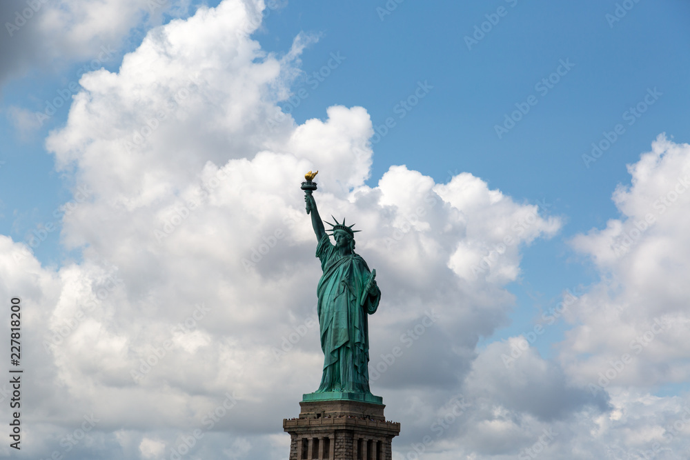 Obraz premium New York City / USA - AUG 22 2018: The statue of liberty in clear blue sky view from river