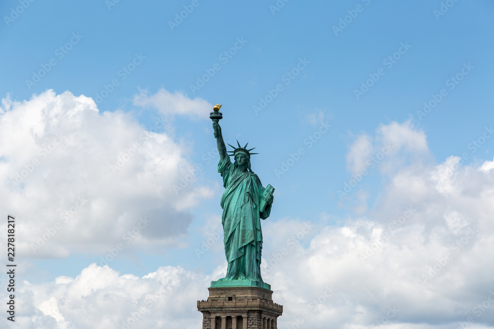Obraz premium New York City / USA - AUG 22 2018: The statue of liberty in clear blue sky view from river