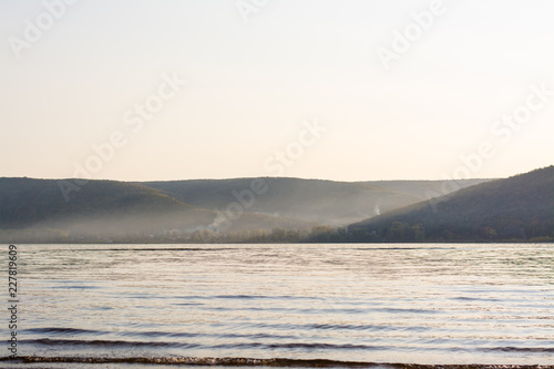 Evening landscape  mountains in the sunset haze  a wide river and a village at the foot of the mountains on the opposite shore. Zhiguli Mountains  Volga River  Samara Region