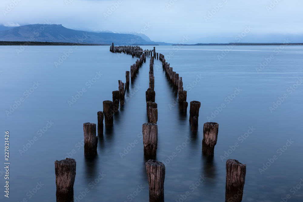 Old wooden pier pillars in in Puerto Natales, Patagonia, Chile Old wooden pier pillars in in Puerto Natales, Patagonia, Chile