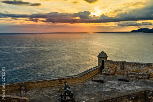 Photography San Pedro de La Roca old Spanish fort walls with cannons, Caribbean sea sunset v