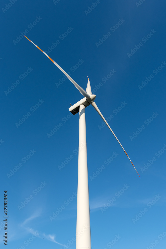 Wind turbine against blue sky. Wind energy. Eco concept. Wind turbine against blue sky. Wind energy. Eco concept.