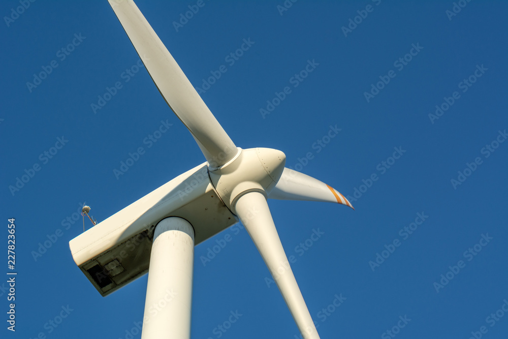 Wind turbine against blue sky. Wind energy. Eco concept. Wind turbine against blue sky. Wind energy. Eco concept.