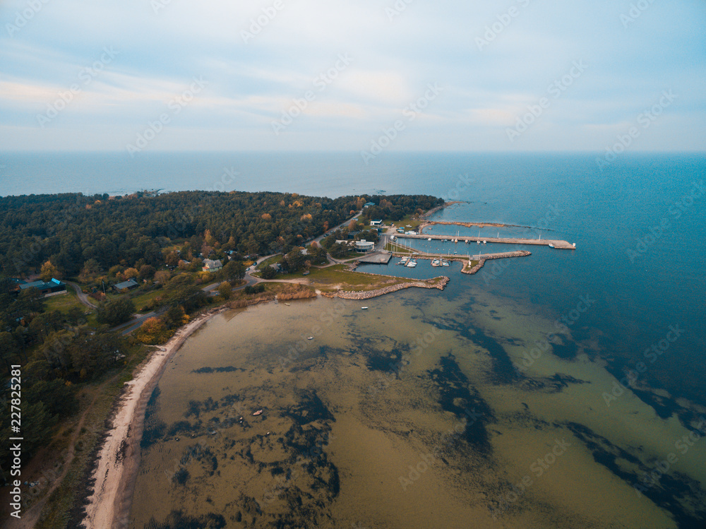 Obraz premium Top aerial view of the harbour for small vessels, both private and fishing boats in the Baltic Sea, Estonian coast