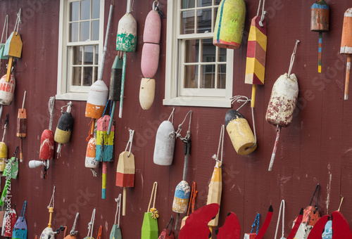 Colorful Buoys hanged on a red wall