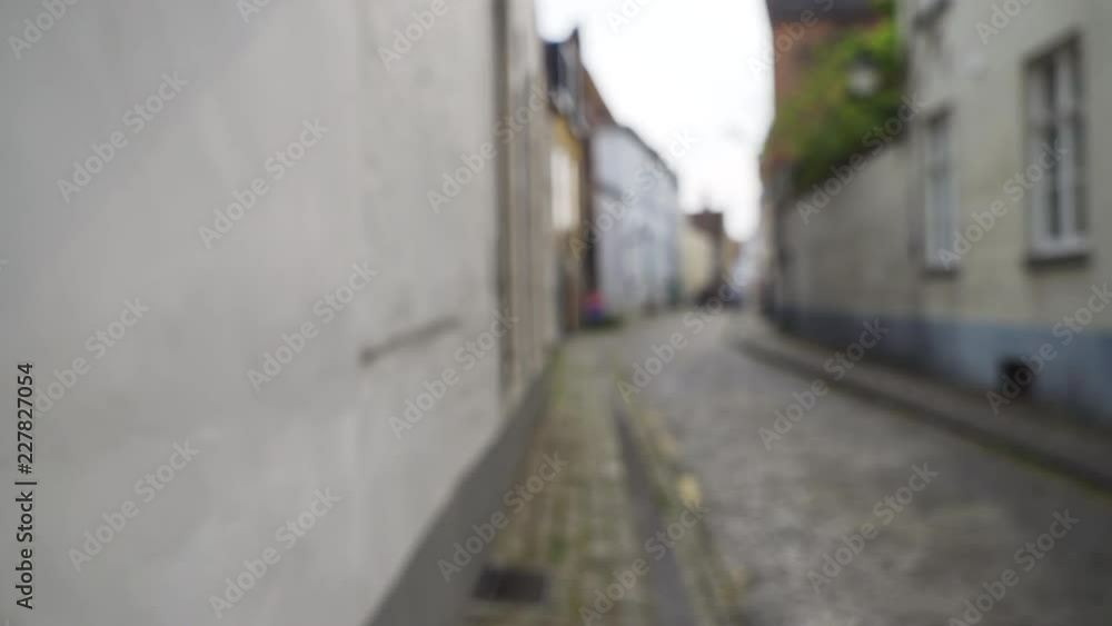 Out of focus background plate of European Cobblestone Street in Bruges Out of focus background plate of European Cobblestone Street in Bruges