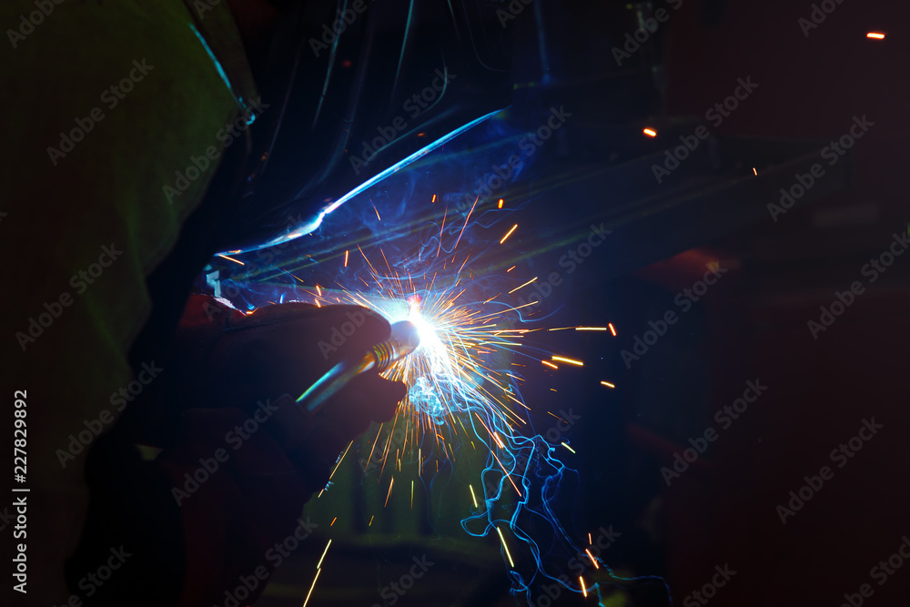 sparks during welding at the production process in semi-automatic welding of metal in argon protective gases sparks during welding at the production process in semi-automatic welding of metal in argon protective gases