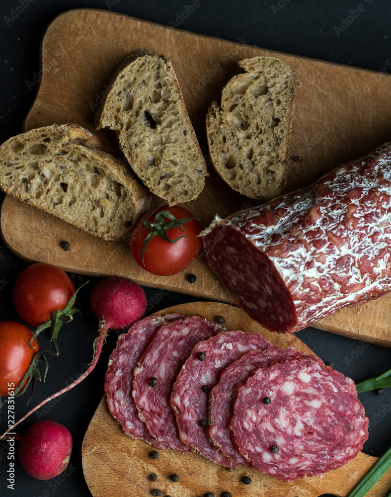 Sausage, bread and vegetables pieces background Sausage, bread and vegetables pieces background
