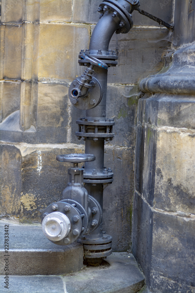The complex element of the plumbing system outside the old building The complex element of the plumbing system outside the old building