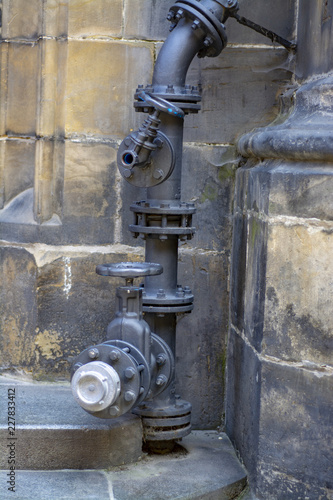 The complex element of the plumbing system outside the old building