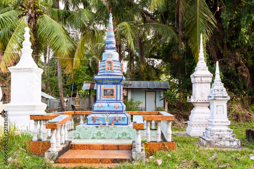 Ornately decorated Buddhist grave shrines located in grave yard - Don Khong Island temples, Laos, Asia