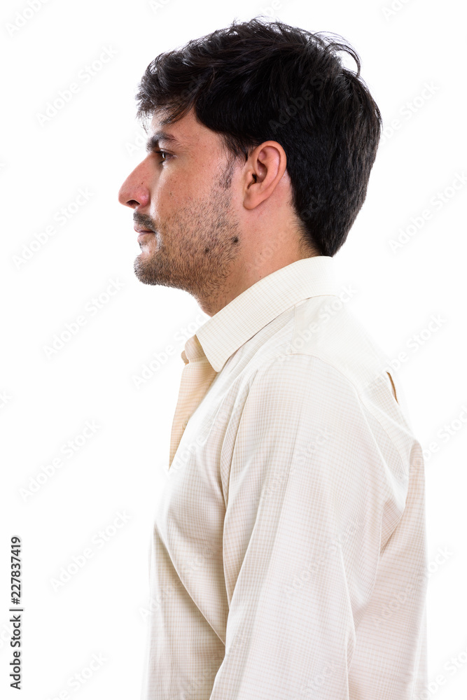 Profile view of young handsome Persian businessman Profile view of young handsome Persian businessman